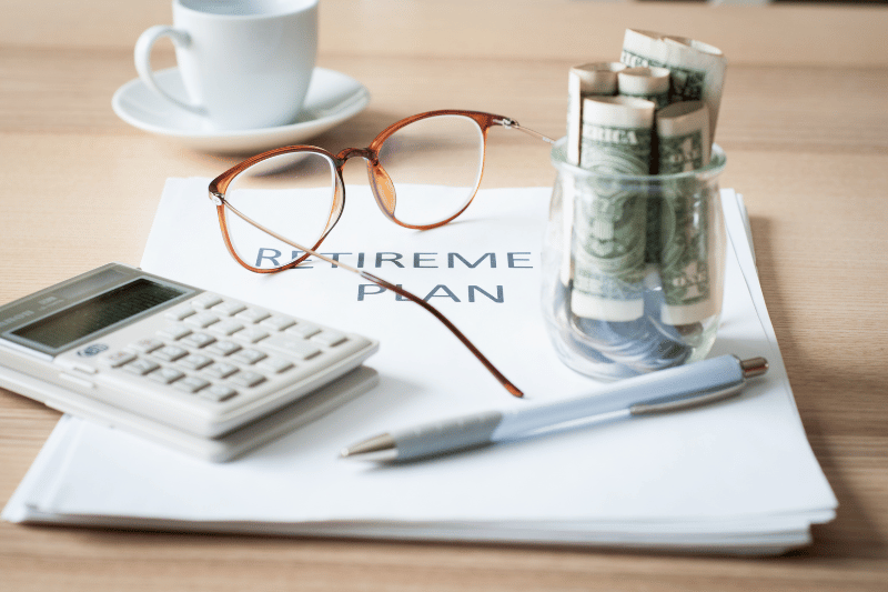 retirement plan personal finance for nurses planner on desk with glasses and money jar