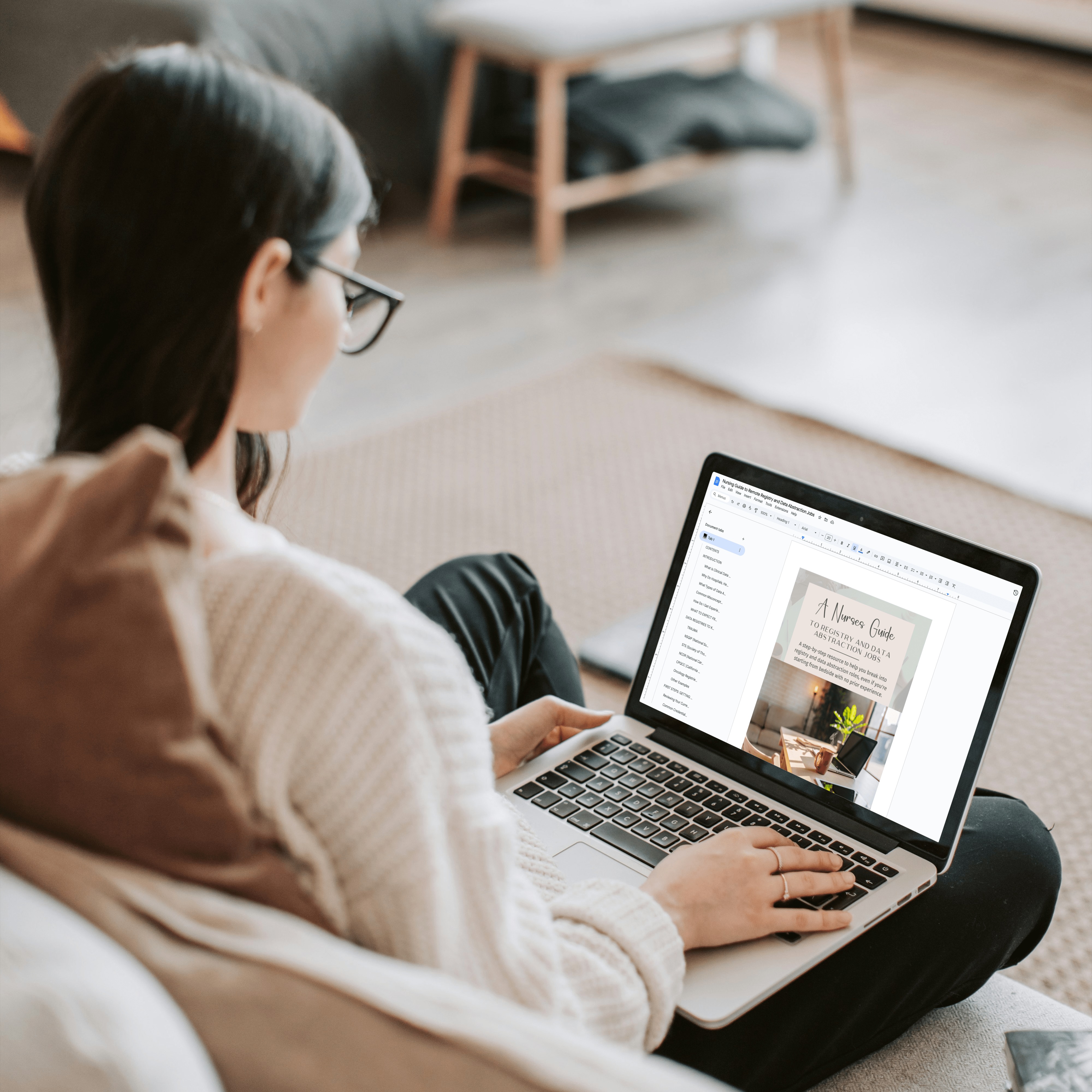 Nurse looking at Data Abstraction Jobs Guide sitting on couch with laptop Nurse looking at Data Abstraction Jobs Guide sitting on couch with laptop